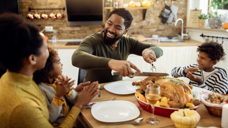 Dad carves Thanksgiving turkey