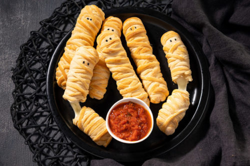 These 3-Ingredient Baked String Cheese ‘mummies’ Are An Easy Halloween Snack Kids Will Love