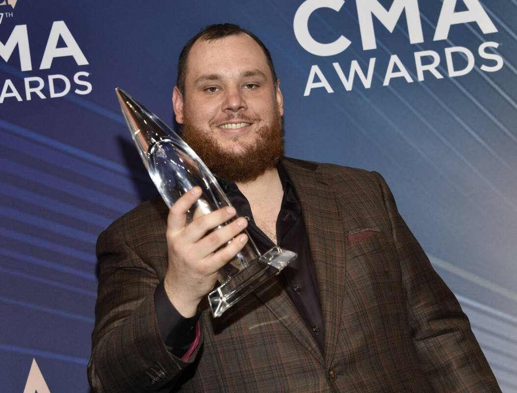 Luke Combs poses with award for song of the year 'Fast Car' at 2023 CMAs
